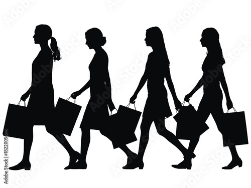 Silhouette of four women walking with shopping bags in their hands