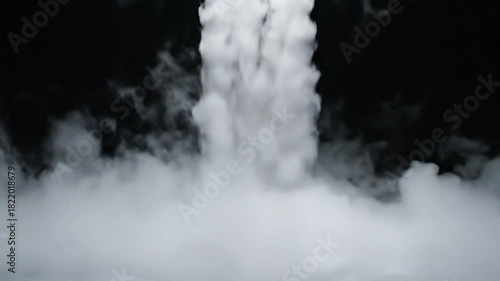 Thick white smoke or fog rising dramatically from the bottom against a solid black background