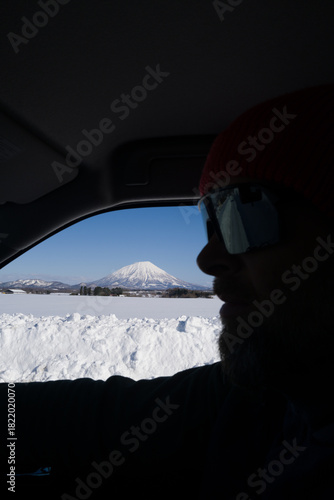 Man driving overlooking mount Yotei in Hokkaido