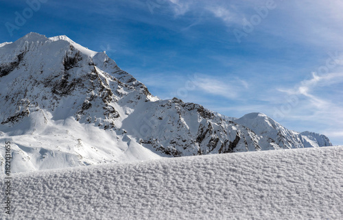 view on snow capped peak mountain and ice down  under blue sky in alpine ski ...