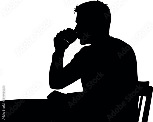 Man silhouette drinking coffee at table