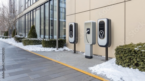 Fototapeta Naklejka Na Ścianę i Meble -  A modern small wooden house showcases striking black and orange walls, with a white lamp post at the entrance, surrounded by a serene winter landscape and snow-covered roof