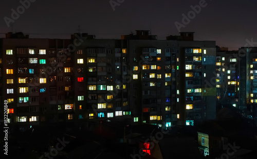Wallpaper Mural Apartment building with windows with lights on at night Torontodigital.ca