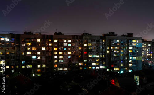 Wallpaper Mural Apartment building with windows with lights on at night Torontodigital.ca