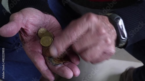 Elderly man's wrinkled hands counting euro coins