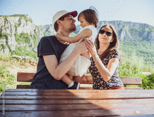 A happy family with a young daughter enjoying a day in nature

