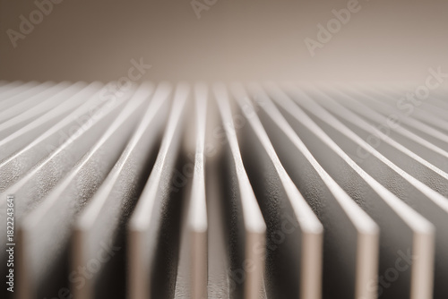 Close-up view of heat sink fin array with repeating lines and shallow depth effect