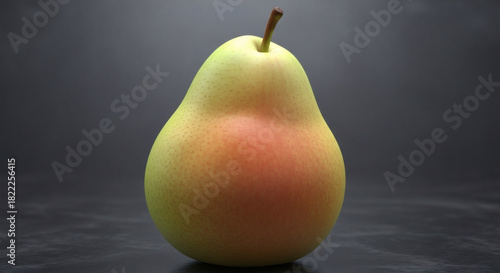 A ripe, unblemished pear resting on a dark surface, its full, bottom-heavy form a classic symbol of voluptuousness, studio lighting highlighting its perfect skin