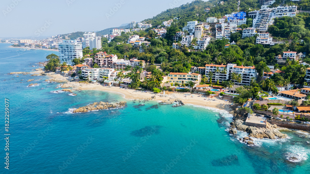 Fototapeta premium Conchas chinas beach with turquoise water and hillside resorts on a sunny day in mexico
