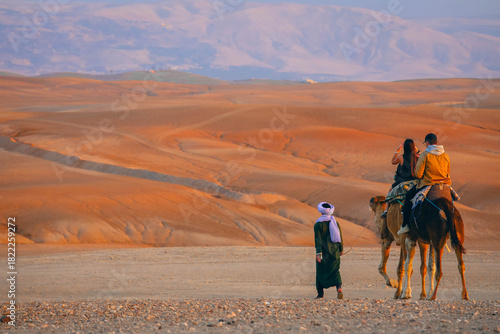 Camel caravan going through the sand dunes in the Desert, Morocco