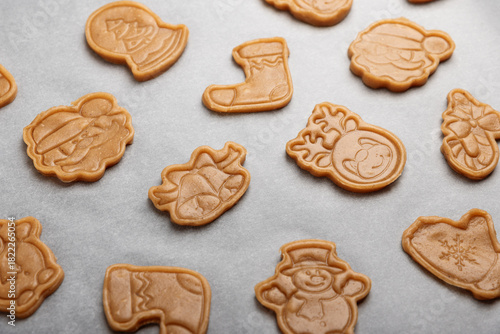 Unbaked Christmas Holiday Cookies with Festive Shapes on Baking Tray
