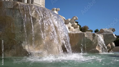 Refreshing water cascading down a majestic stone fountain.