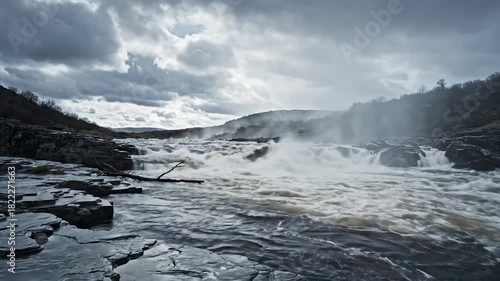 Powerful River Rapids and Waterfalls Under a Dramatic Cloudy Sky.