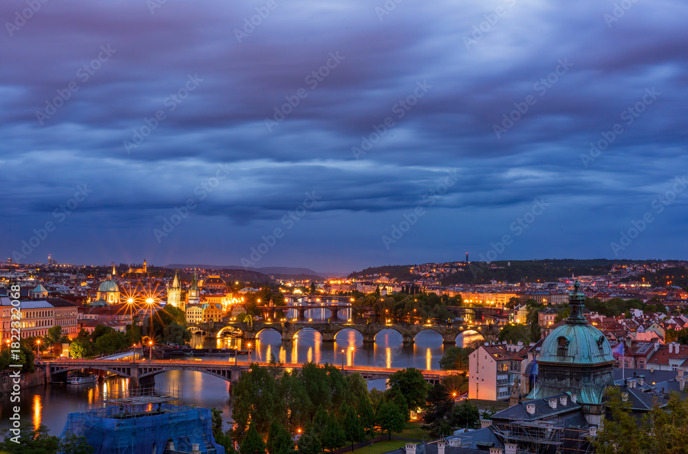 Fototapeta premium Scenic night view of Prague bridges at twilight. Manes, Charles, Legion and Jirasek bridges across the Vltava river. Downtown of Prague city, Czech Republic