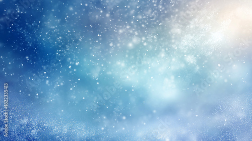 Abstract blue winter background with soft glowing snowflakes  