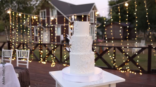 White wedding cake on a white table