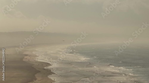 Surfers Riding Waves from Above at Costa da Caparica
