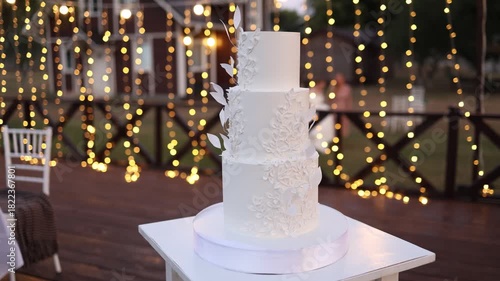 White wedding cake on a white table