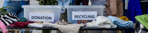 Young woman brings old clothes for recycling, charity, donation. Eco conscious responsible lifestyle. Volunteers sorting textile to prevent pollution, environment protection. Second hand shopping