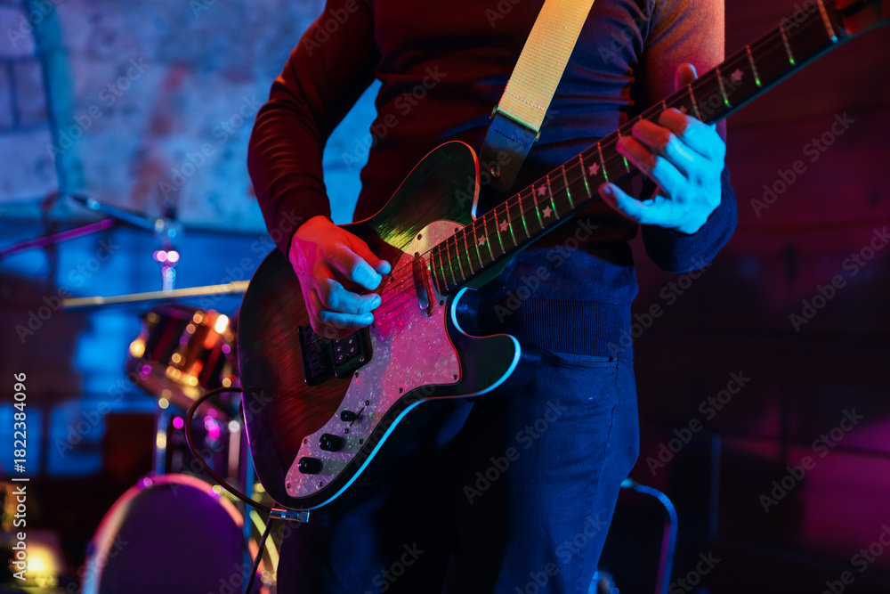 Naklejka premium Man playing electric guitar on stage, closeup