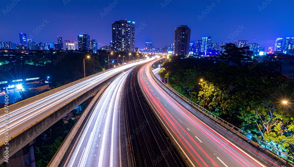 Fototapeta premium Aerial Blurry City Highway at Night with Light Trails in Winter