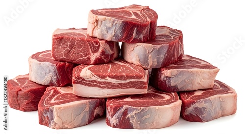 Fresh raw beef chuck eye steaks stacked on a white surface ready for cooking