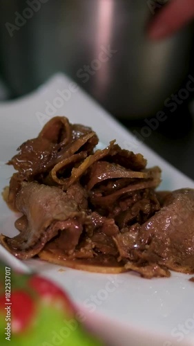 Marinated tongue with sesame seeds, cucumber, and paprika, deliciously served on a long plate at Delicatessen restaurant. High quality 4k footage