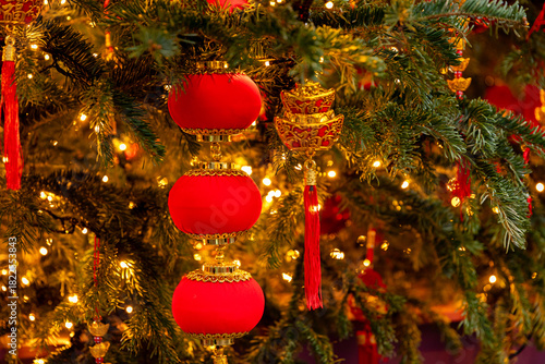 Chinese-style Christmas tree toys and lights on green Christmas tree. Festive background. Chinese New Year in Moscow. High quality photo