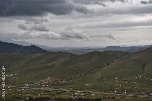 Gray skies over green hills