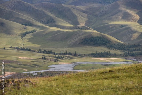 Green landscape with hills and a river
