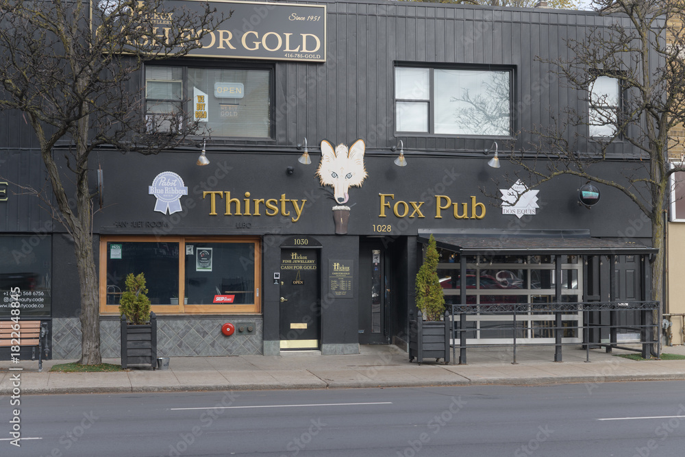 Fototapeta premium exterior building facade and sign of Thirsty Fox Pub, a pub, located at 1028 eglinton Av W, Toronto