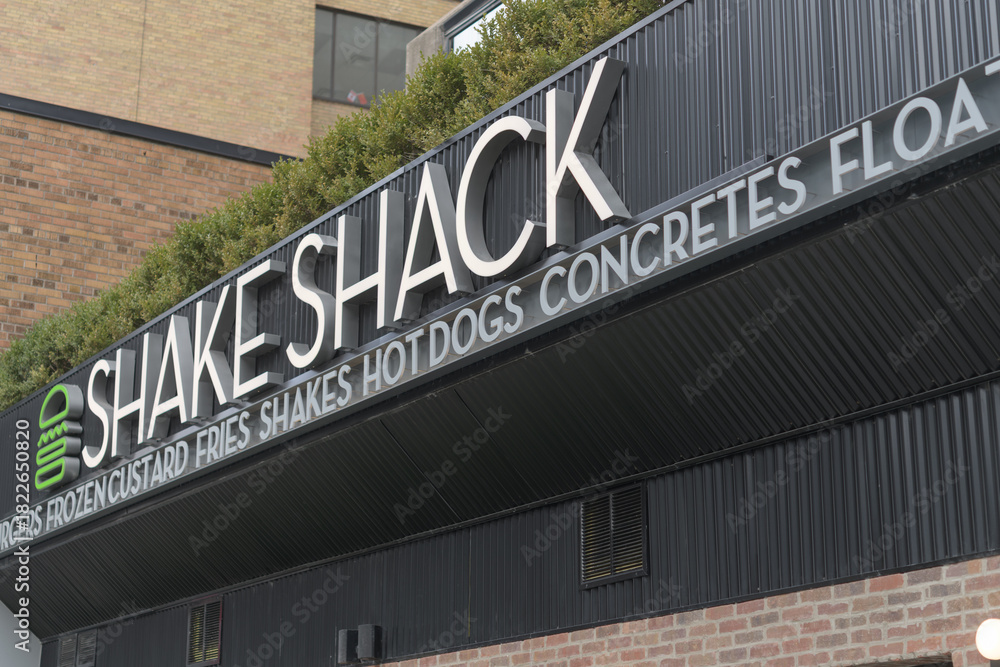 Fototapeta premium exterior building facade and sign of Shake Shack, a hamburger restaurant, located at 40 Eglinton Av E, Toronto