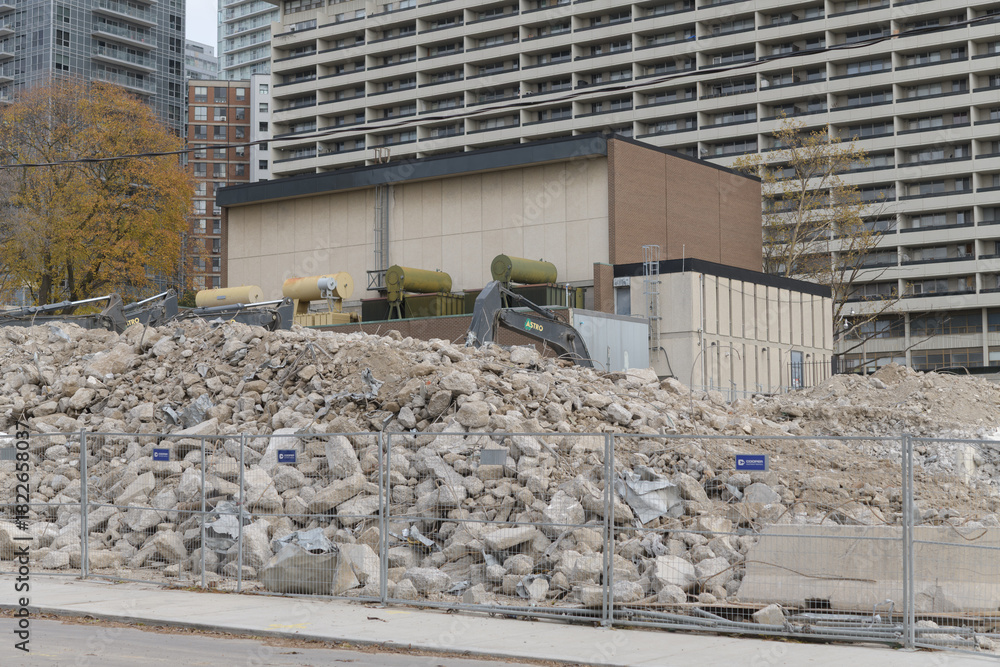 Fototapeta premium demolition of building (90 Eglinton Av W) near Yonge Eglinton featuring automobile, scaffolding, heavy construction machinery, and rubble, Toronto