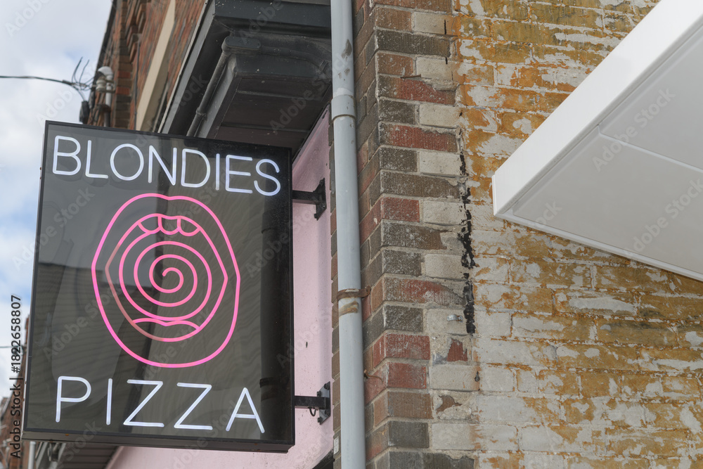 Obraz premium projecting sign outside Blondies Pizza Eglinton, a pizza restaurant, located at 280 Eglinton Av W, Toronto