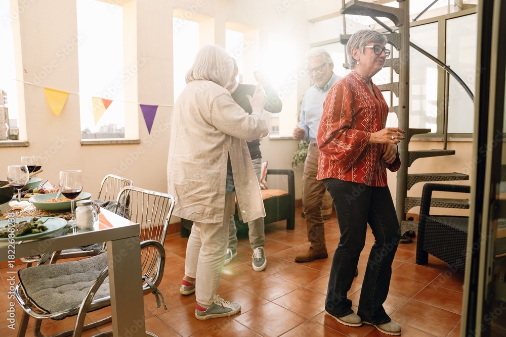 Fototapeta premium A woman walks away from a group of three friends dancing behind her