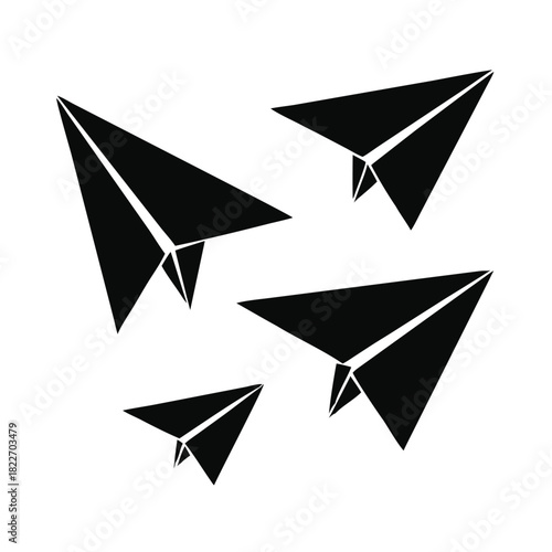 Four black paper airplanes flying in different directions symbolizing communication travel and creative freedom