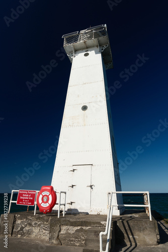 The white and red trimmed Sodus Point Lighthouse at Sodus Bay on Lake Ontario in New York State