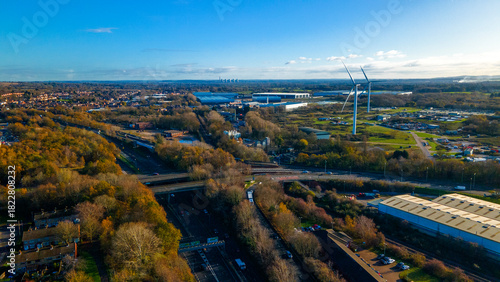 Industrial wind turbines near motorway and commercial logistics