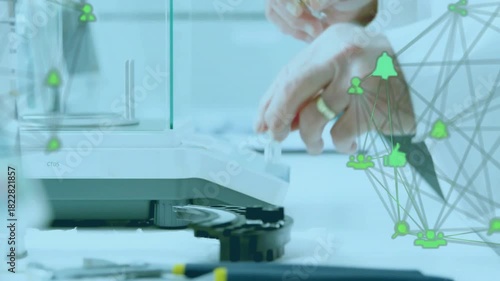 Lab scientist placing sample on balance, drawing, dispensing drops for assay, green net near hands