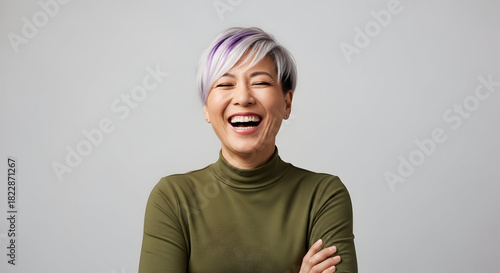 A cheerful woman with a vibrant smile, her laughter echoing joy and confidence, radiating a sense of positivity and authentic happiness for all to see.