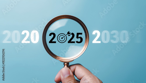 Magnifying glass focuses on the year 2025 and its target, with 2020 and 2030 blurred in the background, symbolizing future planning and goal achievement