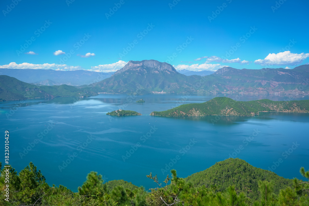 Naklejka premium Beautiful lake scenery with blue sky. Lugu Lake, Yunnan province, China.
