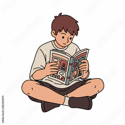 Young boy engrossed in reading a comic book with focused attention.