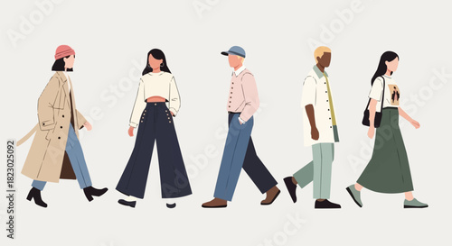 Diverse group of stylish people walking together in a modern urban setting.