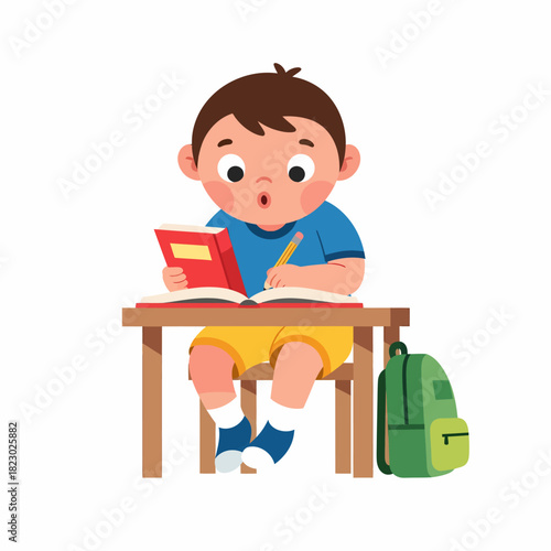 Boy engrossed in reading and writing at his desk.
