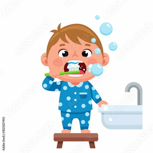 Cute little boy in pajamas brushing his teeth with a toothbrush and toothpaste.