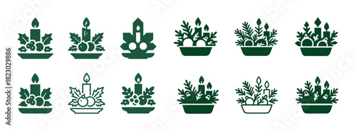 Collection of green holiday candle arrangements with seasonal foliage and ornaments