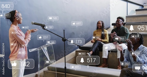 Speaking woman wearing pink top talking to peers on tiered steps, podium mic icons, copy space