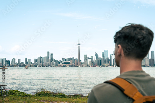 Photography A man gazes out at the city skyline with awe and admiration, outdoors