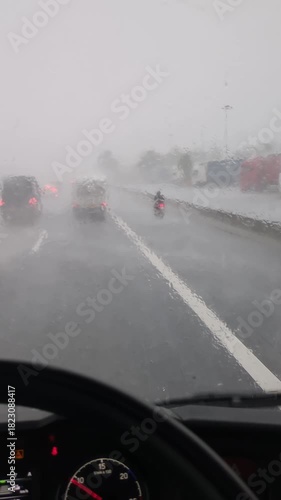 Truck driver navigating heavy rain and fog on a dangerous highway